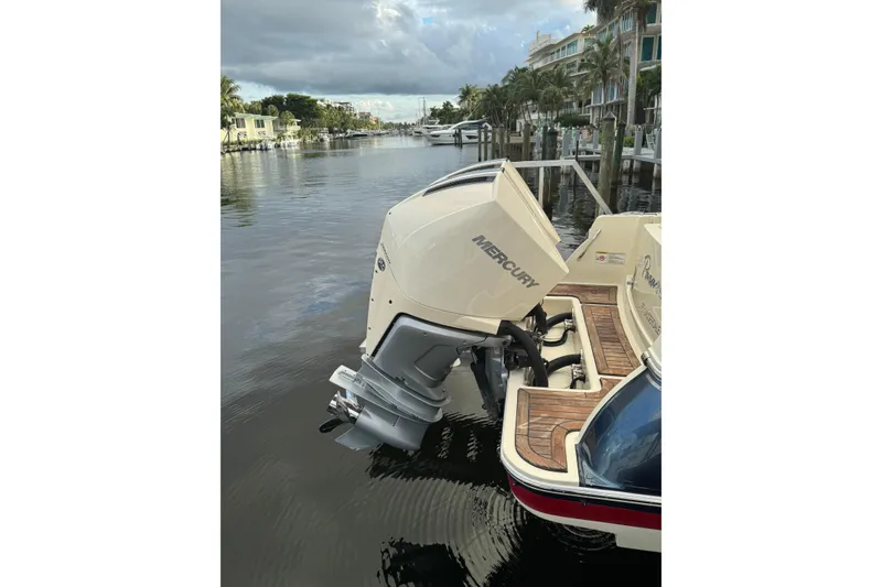 Slide: The Image of 2023 Chris-Craft Catalina 30 with Mercury outboard engine docked on a calm waterway. - 16