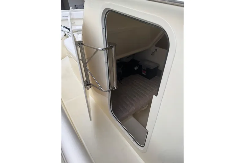 Slide: The Image of 2023 Chris-Craft Catalina 30 cabin interior with open hatch and visible storage. - 21