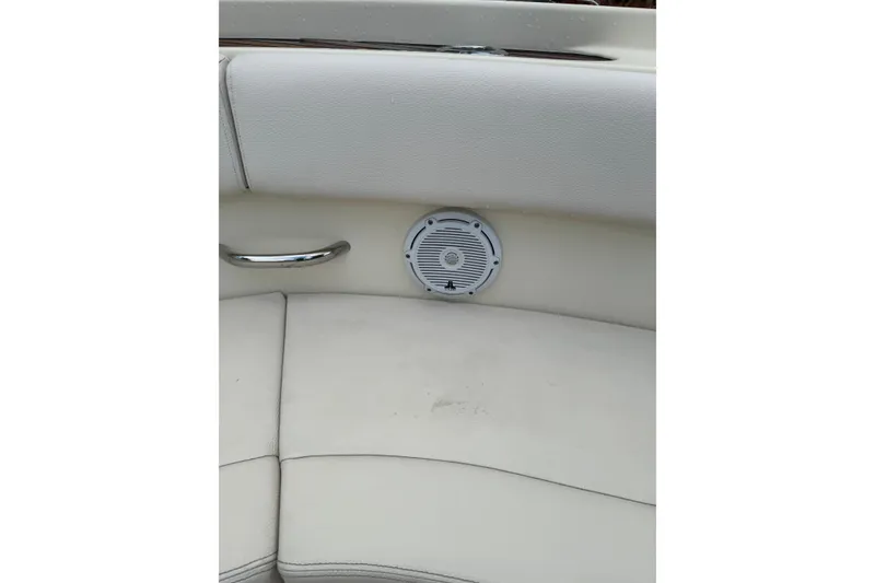 Slide: The Image of 2023 Chris-Craft Catalina 30 interior with white seating and built-in speaker. - 24