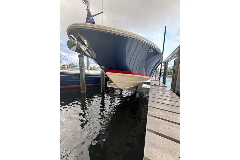 Slide: The Image of 2023 Chris-Craft Catalina 30 boat docked, showcasing sleek design and elegant blue hull. - 26