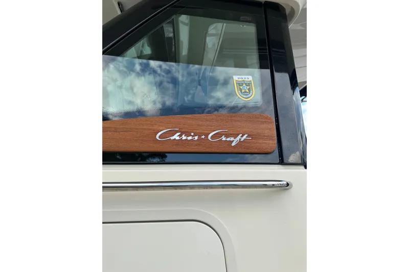 Slide: The Image of 2023 Chris-Craft Catalina 30 boat with logo and window detail. - 3