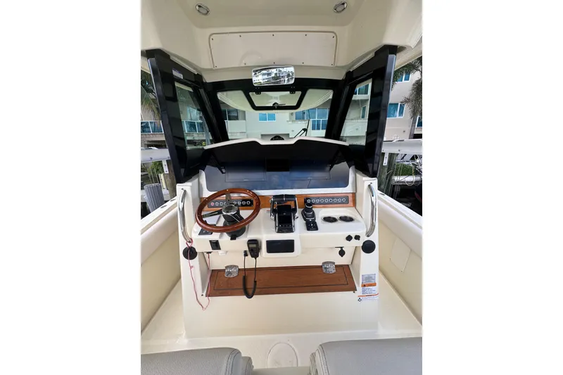 Slide: The Image of 2023 Chris-Craft Catalina 30 helm with modern controls and wooden steering wheel. - 4