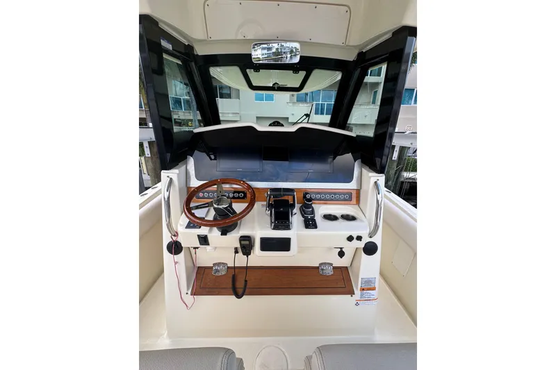 Slide: The Image of 2023 Chris-Craft Catalina 30 helm with wooden steering wheel and modern controls. - 5