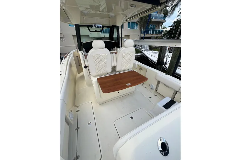 Slide: The Image of 2023 Chris-Craft Catalina 30 interior with elegant seating and wooden table. - 6