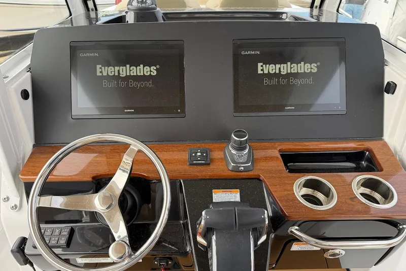 Slide: The Image of 2026 Everglades 315 Center Console dashboard with dual Garmin displays and wooden accents. - 14