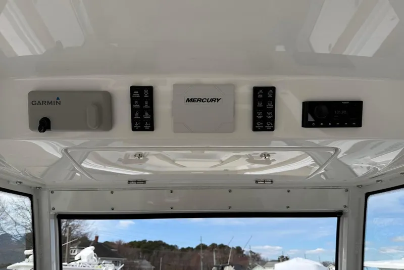Slide: The Image of 2026 Everglades 315 Center Console dashboard with Garmin, Mercury, and Fusion controls. - 15