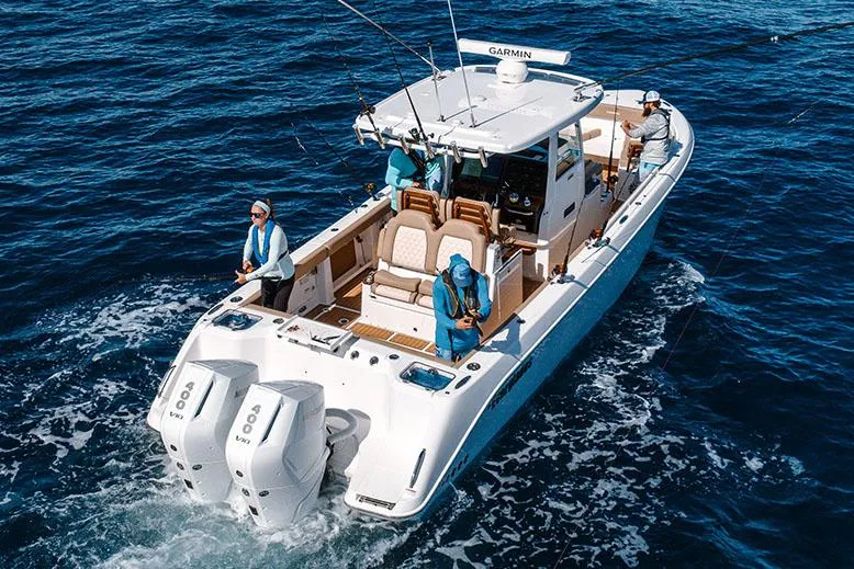 Slide: The Image of Manufacturer Provided Image: 2025 Everglades 315 Center Console boat on open water, featuring dual engines. - 2