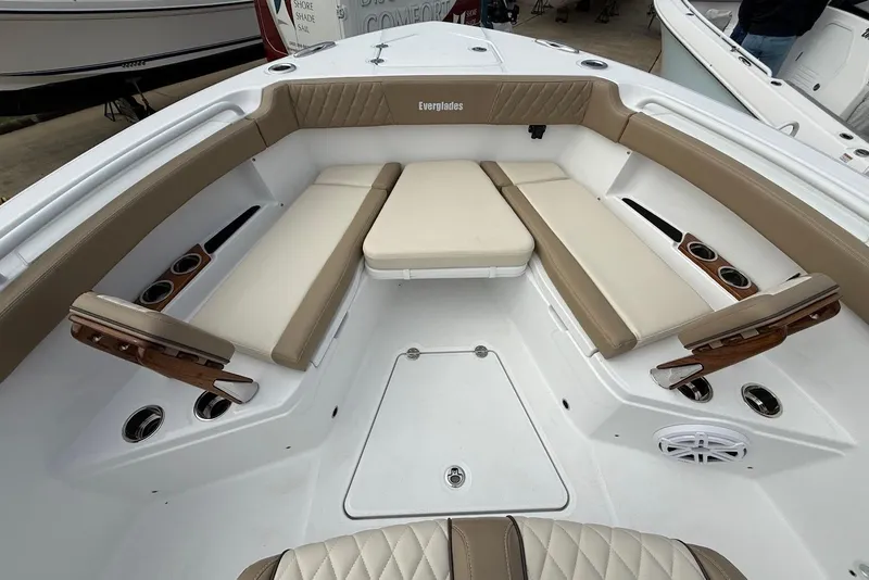 Slide: The Image of 2026 Everglades 315 Center Console boat interior with beige seating and cup holders. - 22