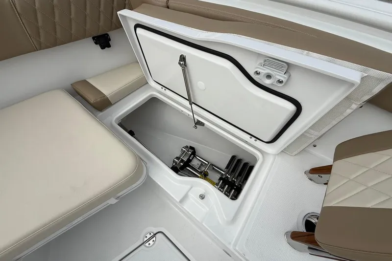 Slide: The Image of Storage compartment on 2026 Everglades 315 Center Console boat with beige seating. - 23