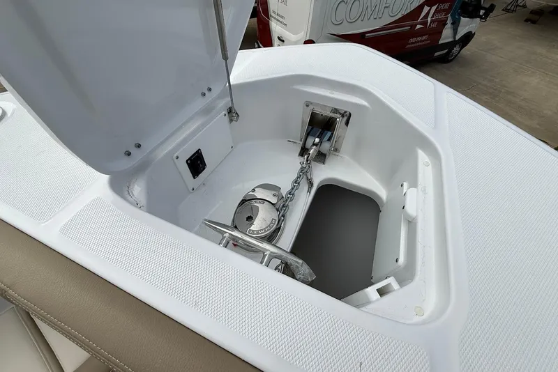 Slide: The Image of Anchor compartment of 2026 Everglades 315 Center Console boat, featuring chain and winch. - 26