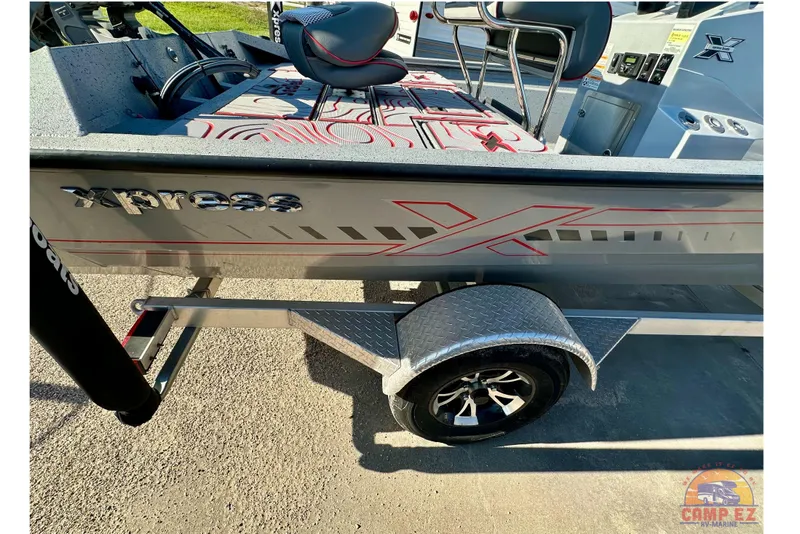 Slide: The Image of 2024 SeaArk SW20B BAY boat on trailer, featuring Xpress branding and modern design elements. - 8