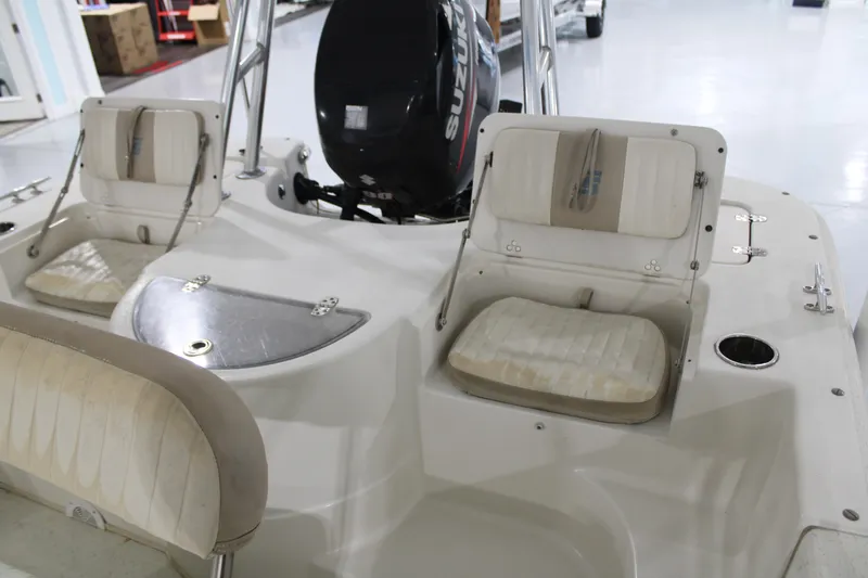 Slide: The Image of 2014 Carolina Skiff 198 DLV boat interior with seating and motor. - 11