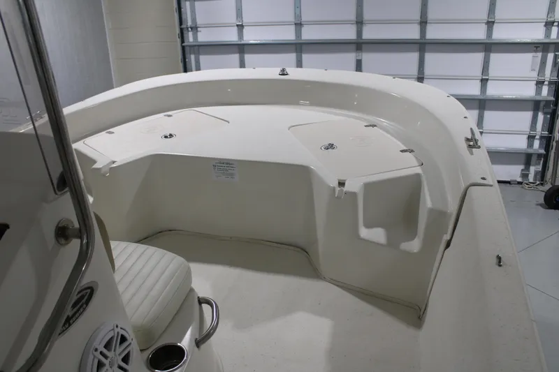 Slide: The Image of 2014 Carolina Skiff 198 DLV boat interior with seating and storage compartments. - 13