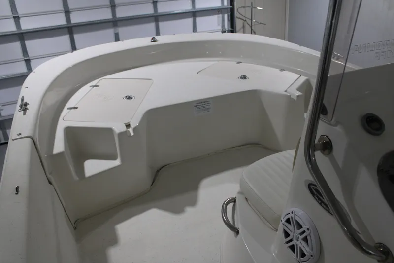 Slide: The Image of 2014 Carolina Skiff 198 DLV boat interior with seating and storage compartments. - 14