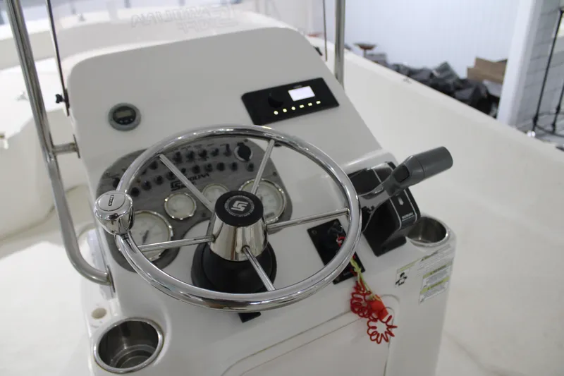 Slide: The Image of 2014 Carolina Skiff 198 DLV boat console with steering wheel and controls. - 16