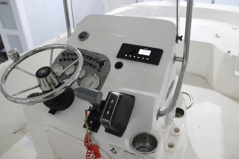 Slide: The Image of 2014 Carolina Skiff 198 DLV boat console with steering wheel and controls. - 17