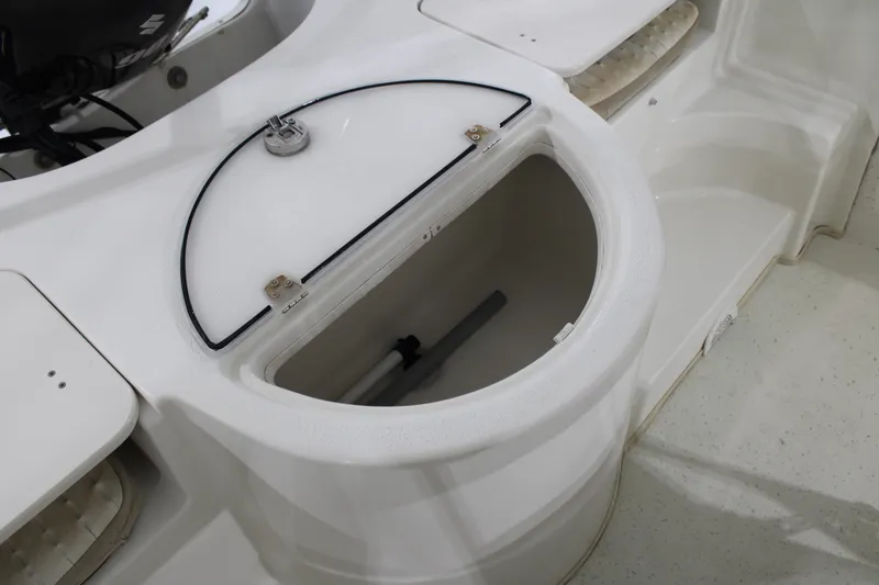 Slide: The Image of 2014 Carolina Skiff 198 DLV boat storage compartment with open lid. - 19