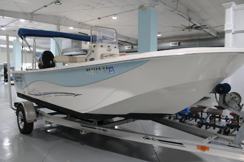 Slide: The Image of 2014 Carolina Skiff 198 DLV boat on trailer in indoor showroom. - 5