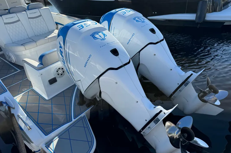 Slide: The Image of Twin Mercury Verado engines on a 2016 Statement 350 Open boat, docked on water. - 11