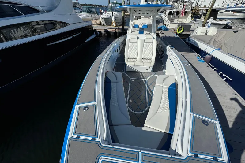 Slide: The Image of 2016 Statement 350 Open boat docked, featuring sleek design and spacious seating. - 2