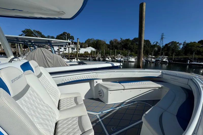 Slide: The Image of 2016 Statement 350 Open boat with white seating, docked at a marina under clear blue skies. - 3