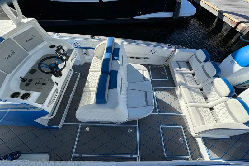 Slide: The Image of 2016 Statement 350 Open boat interior with white seating and Garmin-equipped helm. - 4
