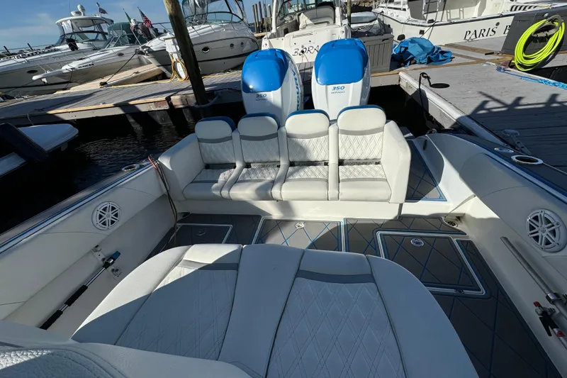 Slide: The Image of Luxury 2016 Statement 350 Open boat interior with plush seating at marina. - 5