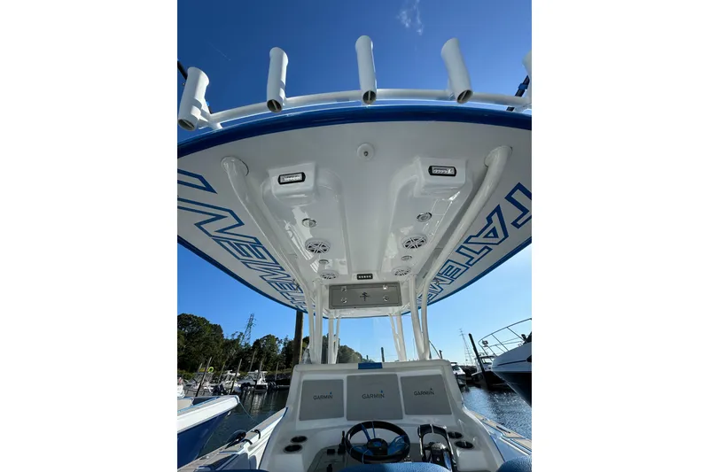 Slide: The Image of 2016 Statement 350 Open boat interior with Garmin displays and rod holders. - 9