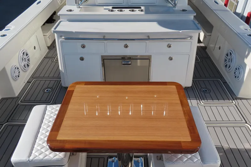 Slide: The Image of Luxury 2018 HCB 53 boat interior with elegant wood table and modern cabinetry. - 10