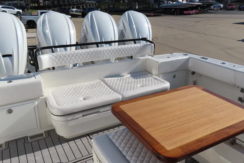 Slide: The Image of Luxury seating and table on 2018 HCB 53 boat with powerful outboard engines. - 13