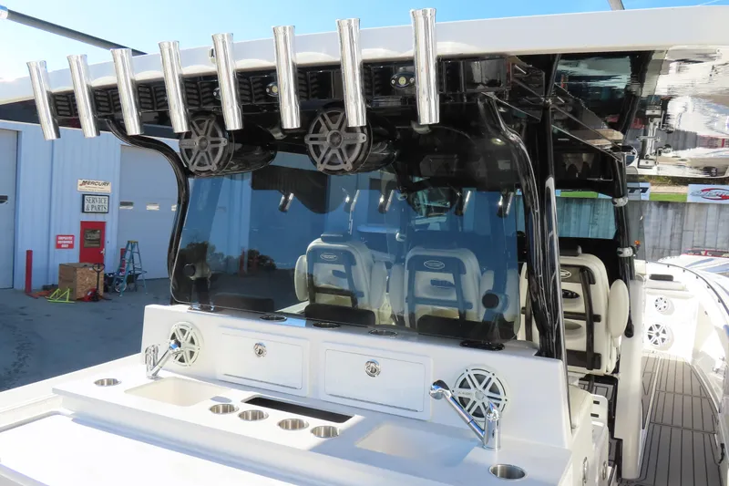 Slide: The Image of 2018 HCB 53 boat with rod holders and seating, docked near service area. - 16