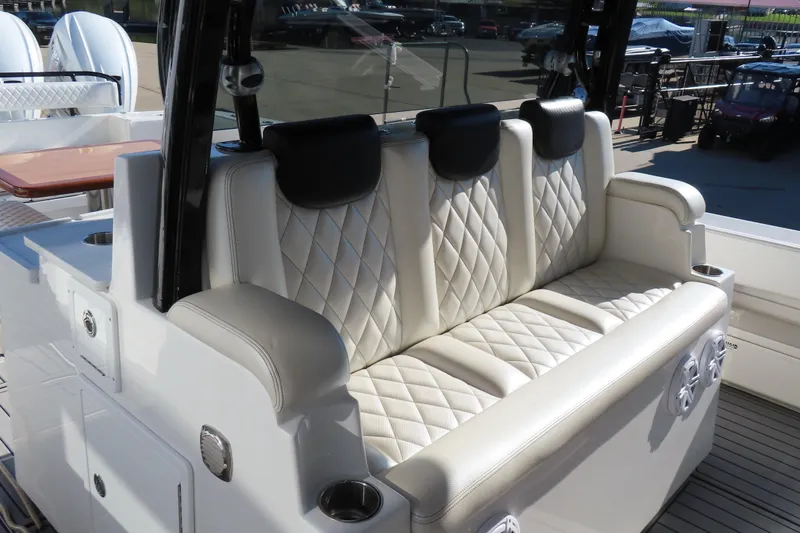 Slide: The Image of Luxurious seating on 2018 HCB 53 boat with quilted upholstery and cup holders. - 18