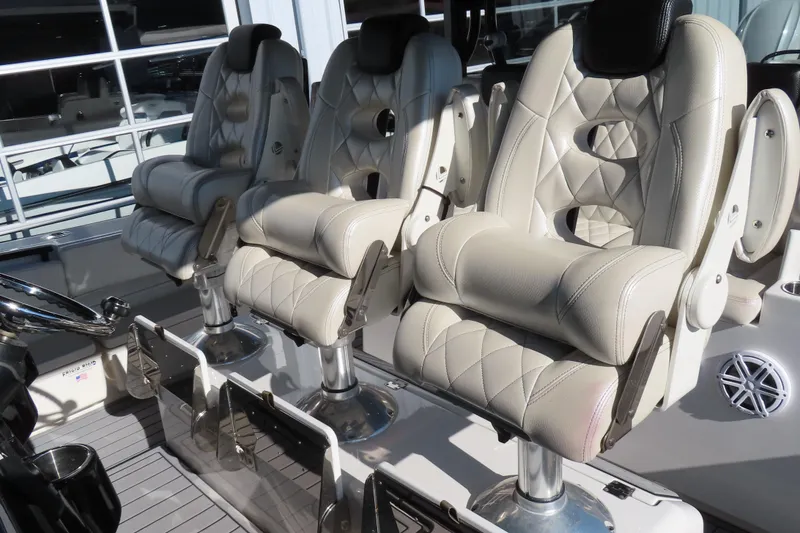 Slide: The Image of Luxurious seating on a 2018 HCB 53 boat, featuring plush, white leather captain chairs. - 20