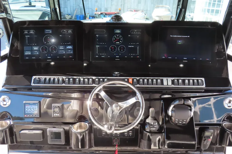 Slide: The Image of 2018 HCB 53 boat dashboard with advanced navigation and control systems. - 22