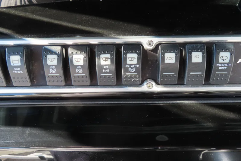 Slide: The Image of Control panel of a 2018 HCB 53 boat with various switches. - 25