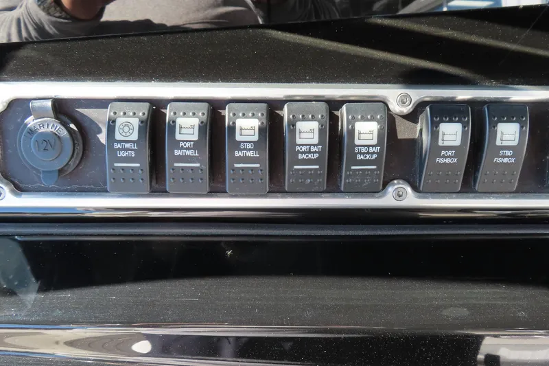 Slide: The Image of Control panel of a 2018 HCB 53 boat with labeled switches and 12V outlet. - 26