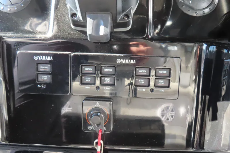Slide: The Image of Control panel of a 2018 HCB 53 boat featuring Yamaha ignition and start/stop buttons. - 28