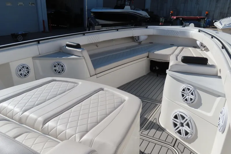 Slide: The Image of Luxurious interior of 2018 HCB 53 boat with white seating and speakers. - 34