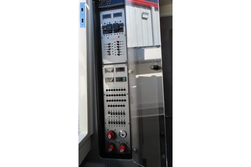 Slide: The Image of Control panel of a 2018 HCB 53 boat, featuring switches and gauges. - 41