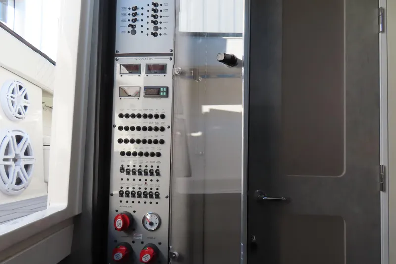 Slide: The Image of Control panel inside 2018 HCB 53 boat, featuring switches and gauges. - 42