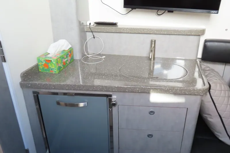 Slide: The Image of Compact kitchenette in 2018 HCB 53 boat with sink, fridge, and tissue box. - 43