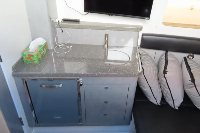 Slide: The Image of Interior of 2018 HCB 53 boat with kitchenette, sink, and seating area. - 45