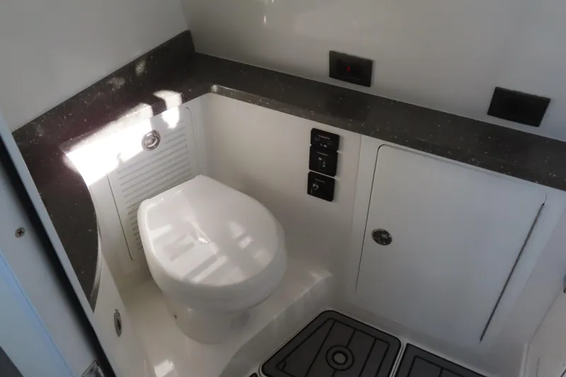 Slide: The Image of Compact bathroom in 2018 HCB 53 boat with modern fixtures and storage. - 47