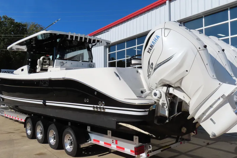 Slide: The Image of 2018 HCB 53 boat with Yamaha engines on a trailer outside a building. - 5