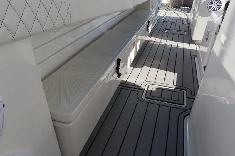 Slide: The Image of 2018 HCB 53 boat interior with cushioned seating and sleek flooring design. - 52