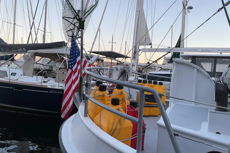 Slide: The Image of Docked sailboats with American flag and fuel containers, Custom Sprague 2006 model. - 10