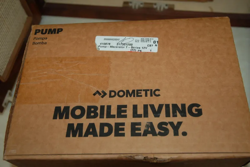 Slide: The Image of Cardboard box labeled "Dometic Pump" with "Mobile Living Made Easy" slogan. - 105