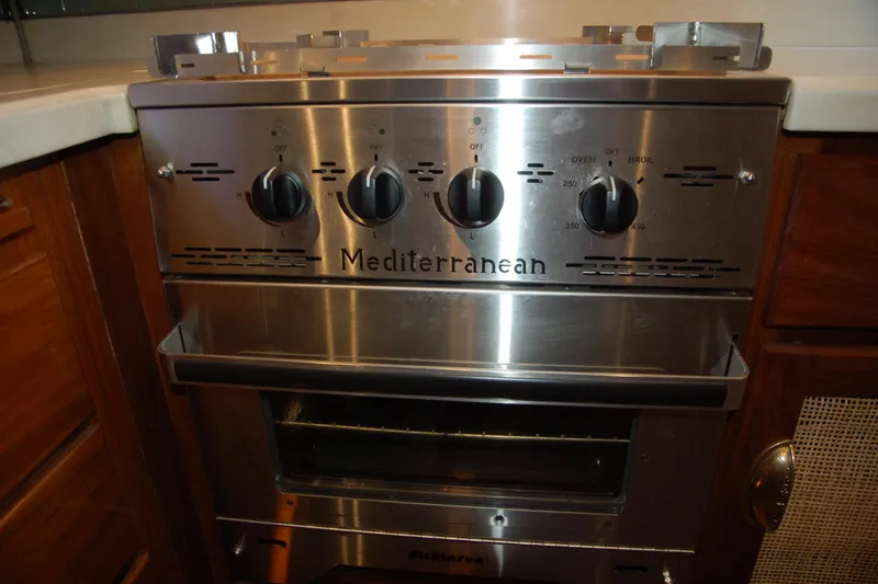 Slide: The Image of Custom 2006 Sprague Mediterranean stainless steel oven with control knobs in a kitchen setting. - 114