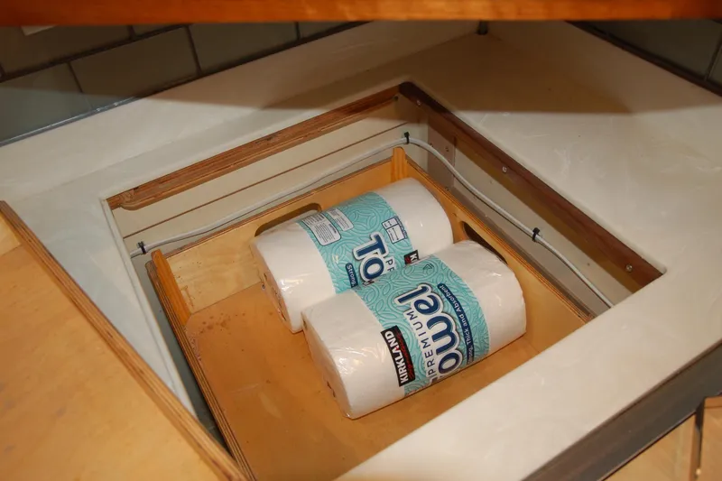 Slide: The Image of Hidden storage compartment with paper towels in a 2006 Custom Sprague model. - 119