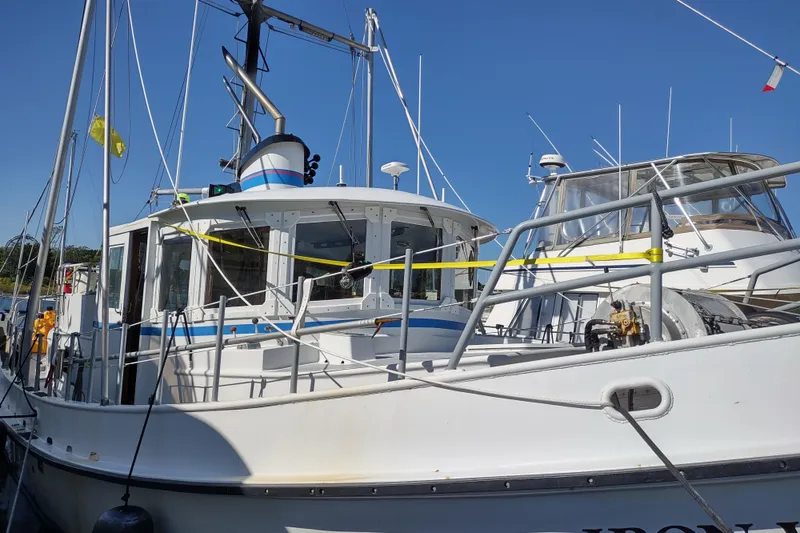 Slide: The Image of Custom 2006 Sprague boat docked, featuring a white exterior and nautical equipment. - 12